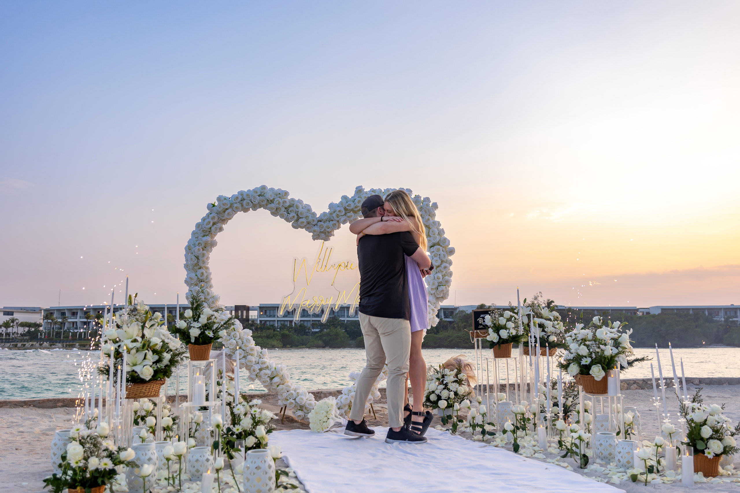 Emotional embrace during a sunset proposal at Conrad Tulum