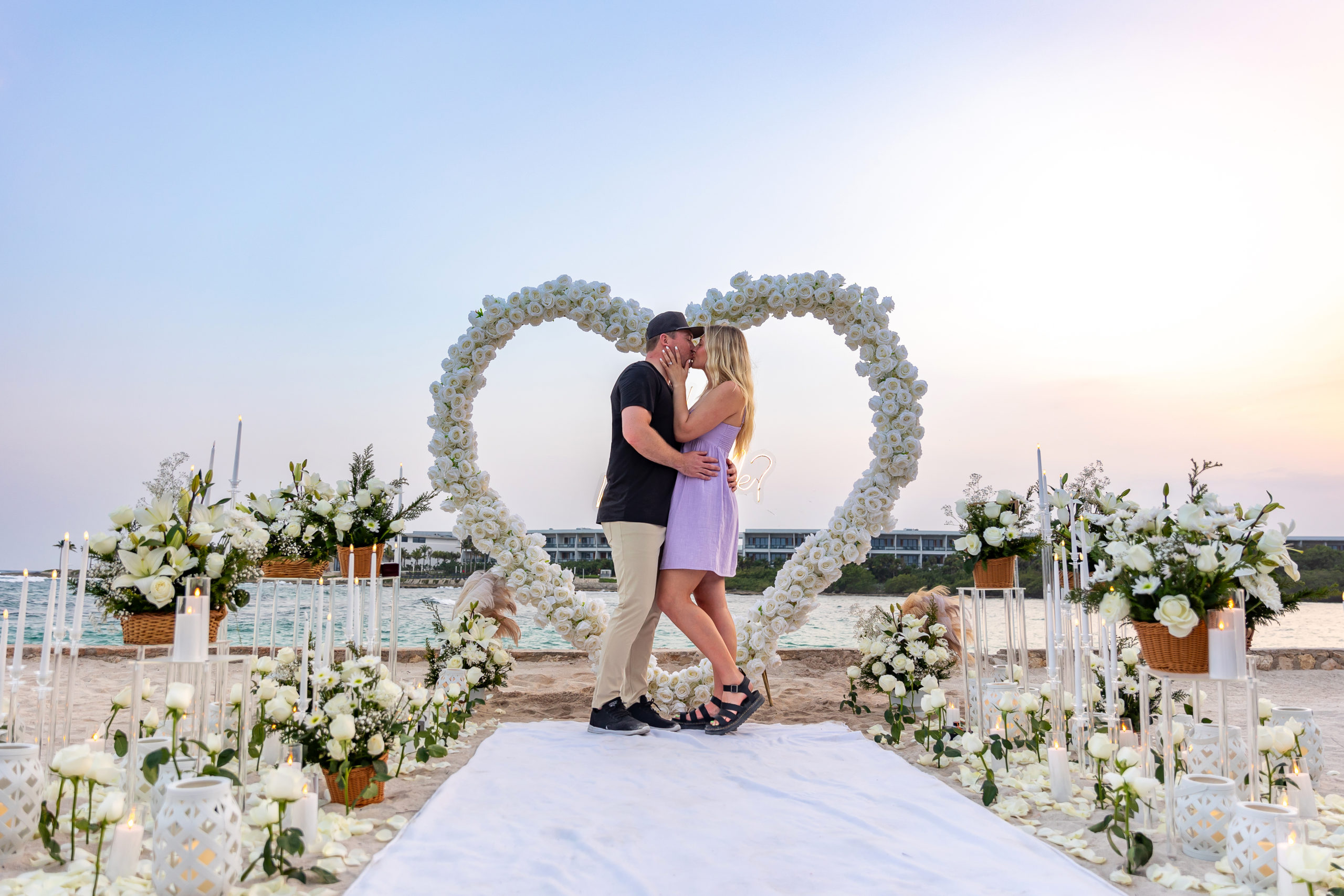 Romantic kiss after a sunset proposal at Conrad Tulum