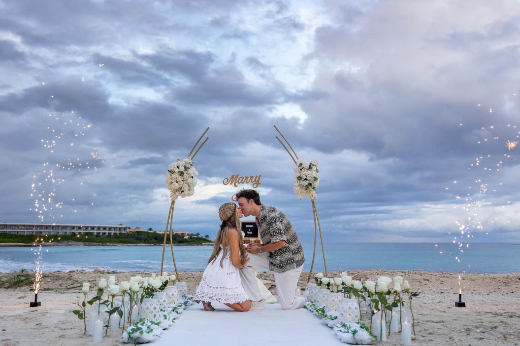 Beach proposal at Hilton Tulum with sparklers, floral walkway, and Marry Me sign