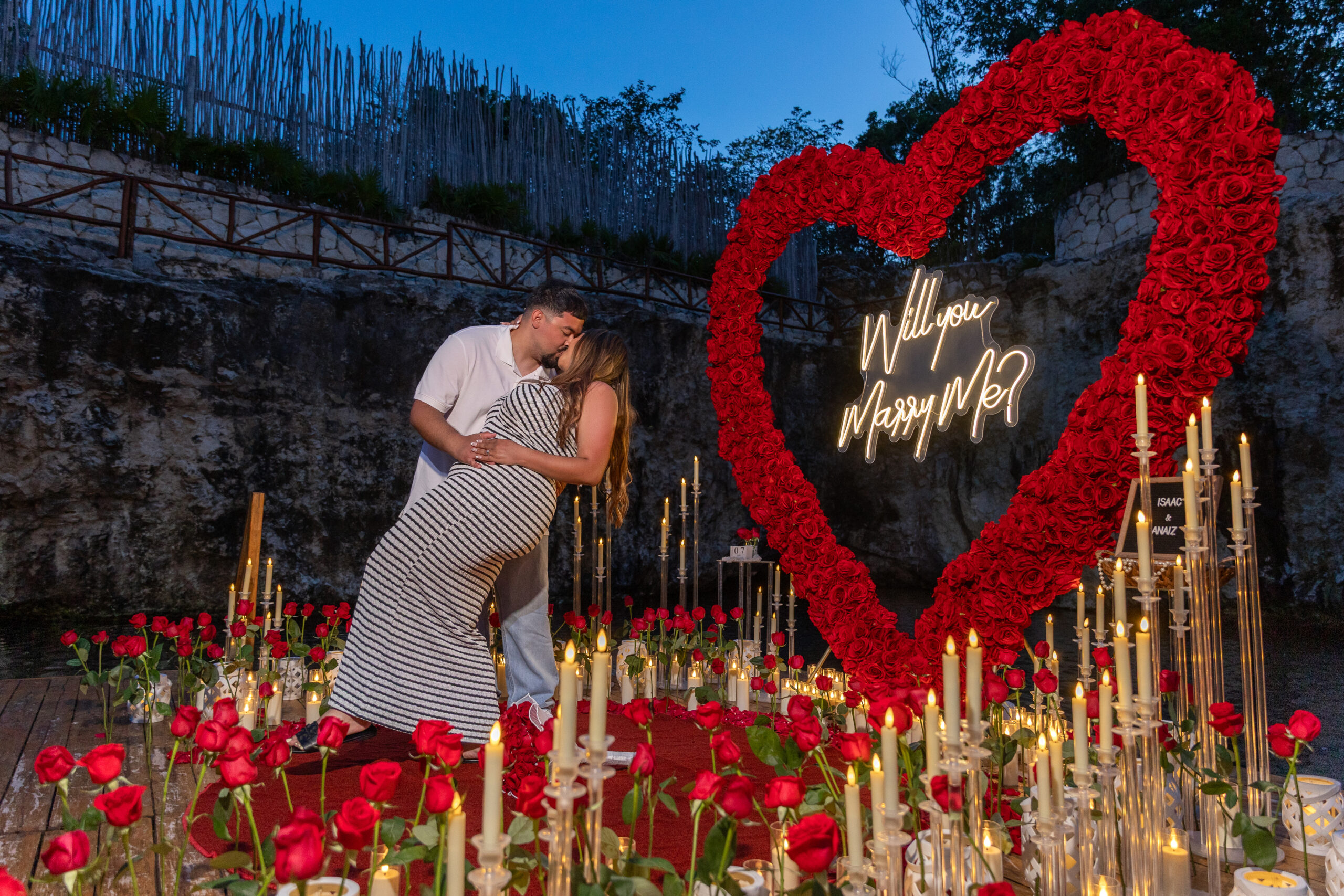 Red floral heart proposal design beside a private cenote