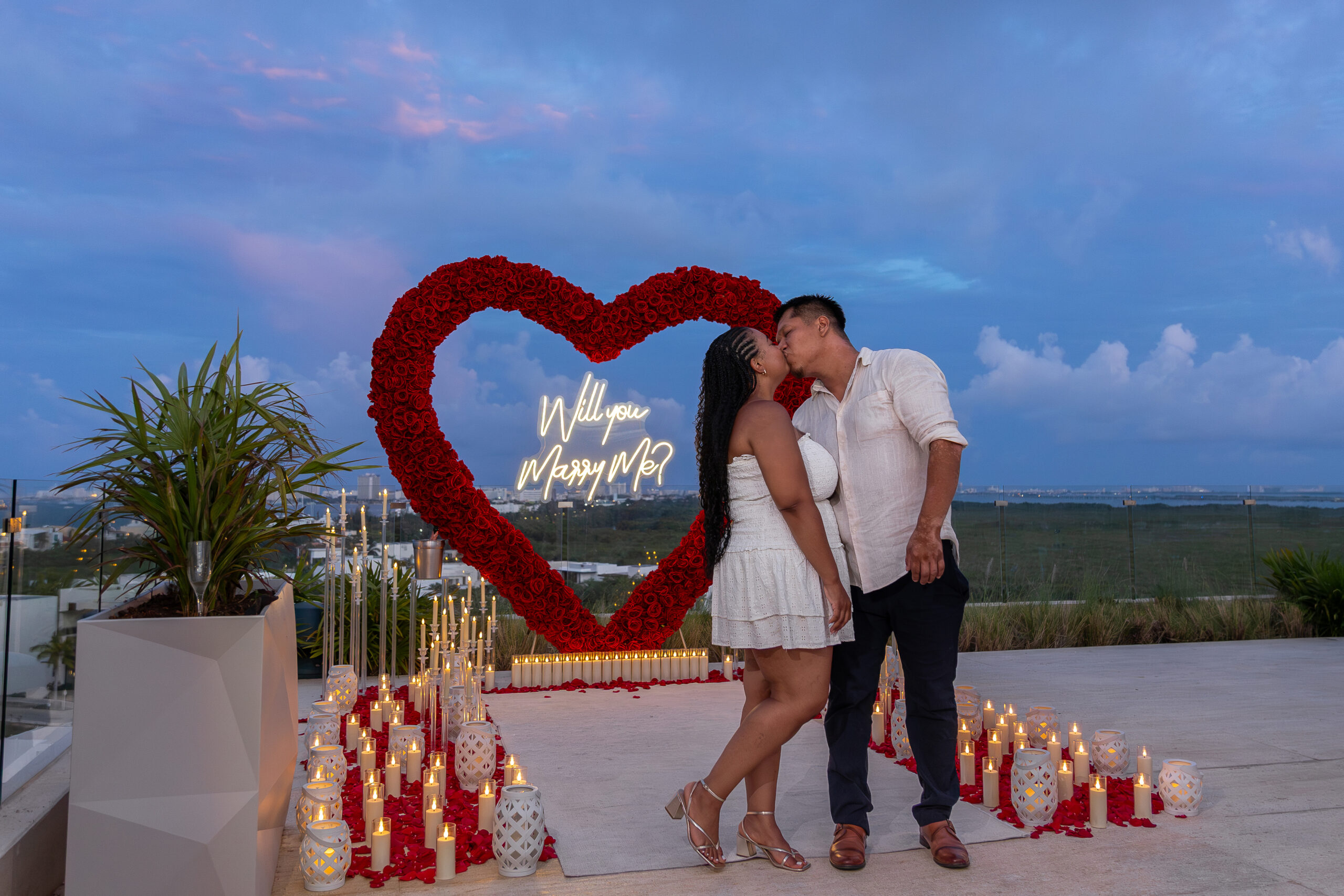 Luxury rooftop proposal in Cancun with red floral heart and candlelight